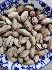 Fresh natural dried pistachios in a decorative plate 