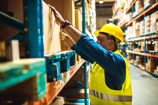 Warehouse worker organizing boxes on shelves