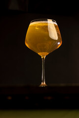 yellow apple juice in a clear glass with bubbles