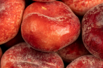 a pile of ripe washed peaches on the table