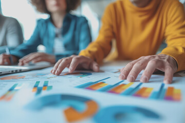 Fototapeta premium Hands business team having a meeting to analyze data graph charts for a marketing plan in the office