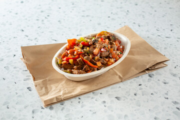 A view of a restaurant style burrito bowl.