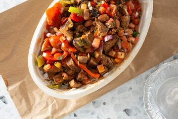 A top down view of a restaurant style burrito bowl.