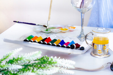 Arts Painting Elements Watercolor brushes, canvas on a table with blur female artist