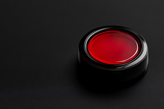 close up of red button on the black background with copy space