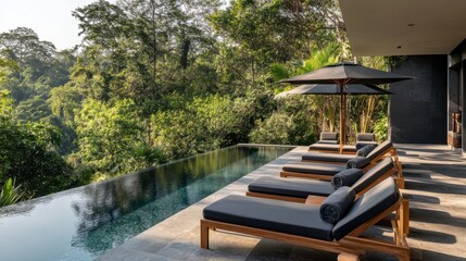 Hotel poolside area with modern loungers and views of
