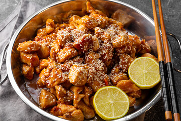 Asian caramelized chicken breast on dark grey background top view