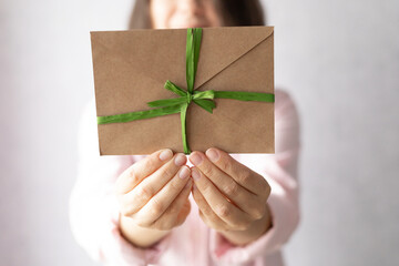 female hands holding a gift certificate, gift voucher or discount