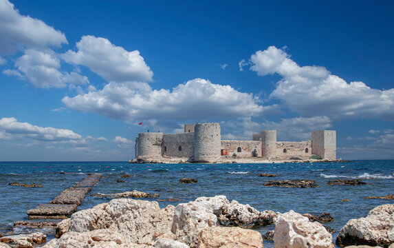 Cloudy sky and Maiden Castle (Kız Kalesi) and rocky field - Mersin, T&uuml;rkiye.