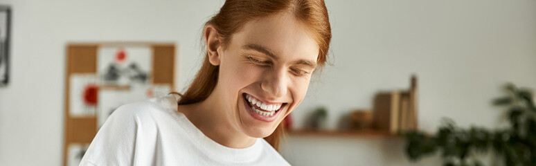 The young man is filled with happiness, laughing while engaged in a fun activity.