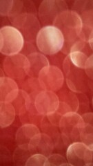 A red background with many small circles. The circles are blurry and overlapping