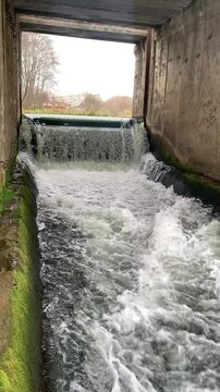 Dam on the river, waterfall with a rapid current