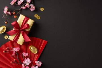 Festive scene featuring a beautifully wrapped gift with red bow, flowers, coins, and traditional decorations for Chinese New Year celebrations