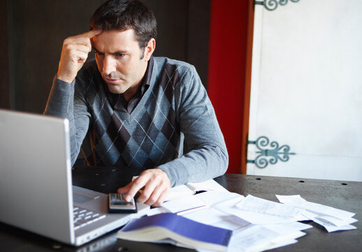 Man with Laptop and Paperwork