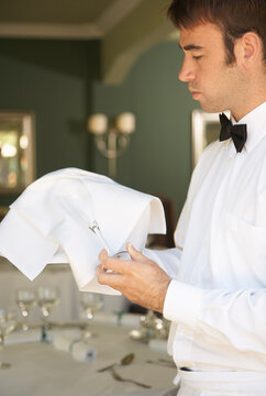 Waiter Polishing Glasses