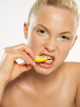 Portrait of Woman Biting Lemon