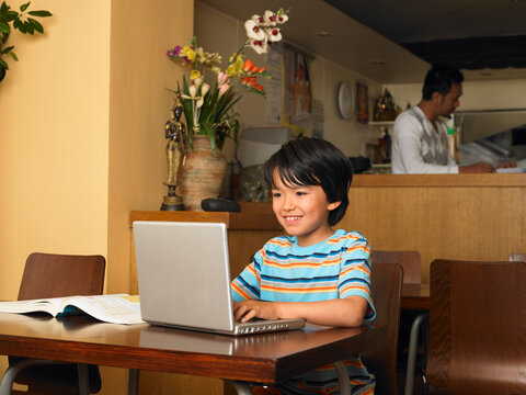 Boy with Homework in Restaurant