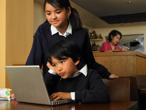 Boy and Girl with Homework in Restaurant