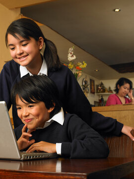 Boy and Girl with Homework in Restaurant