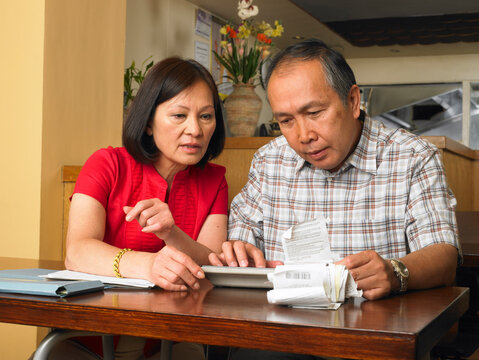 Couple Counting Bills in Restaurant