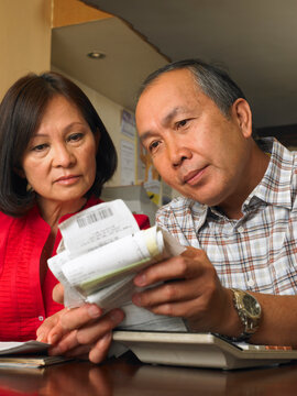 Couple Counting Bills in Restaurant
