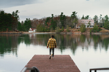 Fototapeta premium Man in the Canadian woodlands, close to a lake, Ontario, Canada