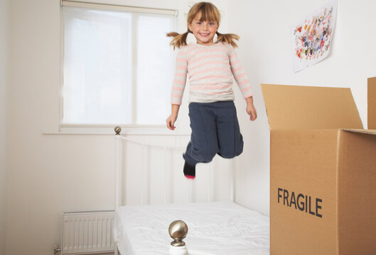 Girl Jumping on Bed