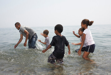 Children Splashing Man in Lake