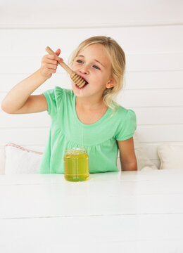 Little Girl Eating Honey