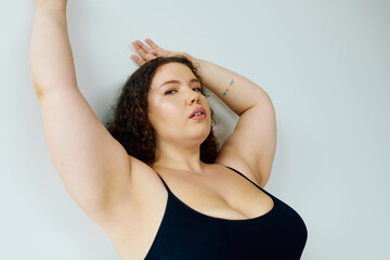 A stunning plus size woman poses gracefully, showcasing her confidence and beauty.