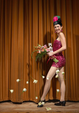 Woman on Stage Holding Flowers