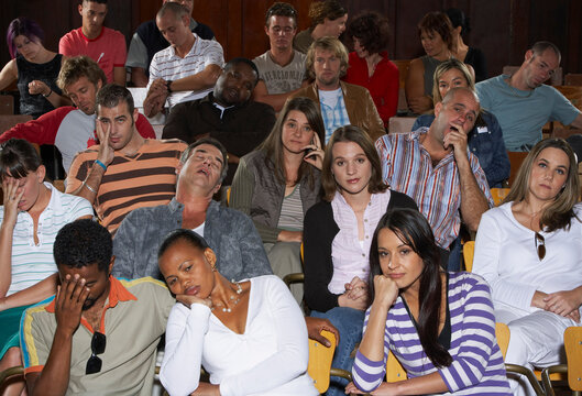 Bored People in Auditorium Seats