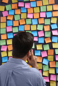 Man Looking at Self-Adhesive Notes