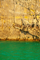 Vertical image of sea water and fantastic rocky stone background. Copy space for text or design.