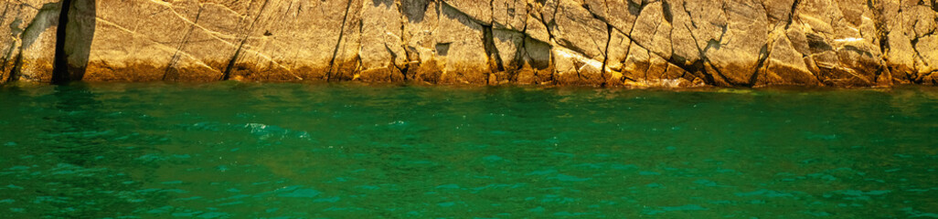 Horizontal image of sea water and fantastic rocky stone background. Copy space for design.