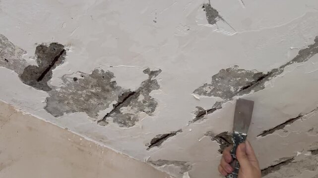 Male hand with spatula,repair concept.