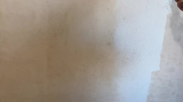 Male hand painting wall,repair concept.