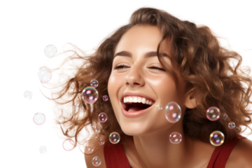 Close-up of a cheerful woman blowing a bubble with a playful smile as bubbles float around her isolated on white background