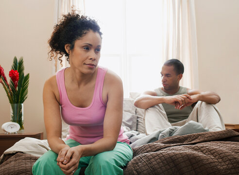Couple Sitting on Bed