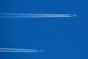 Airplane trails in the blue sky, contrails.