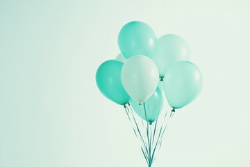 An illustration of a bouquet of balloons in light blue and green, against a white background.