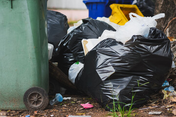 Plastic bins filled with trash and debris in public places