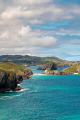 Fototapeta premium Spectacular natural lanscape in north of Spain, Asturias. Green coastline of Spain. High cliff. Turquoise water. Waves breaking on the rock. Famous travel destination. 