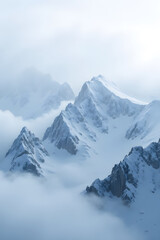 Obraz premium Ethereal snow-capped mountains shrouded in misty fog at sunrise