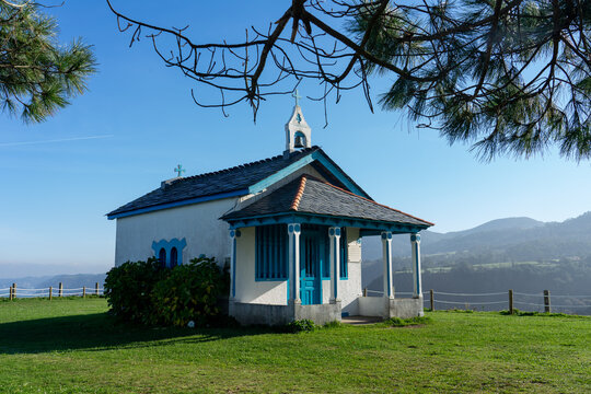Hermitage of the Regalina with the typical Asturian horreos in Cadavedo, Asturias, Spain