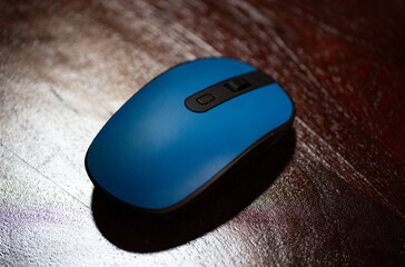 A computer mouse photographed on a desk, showcasing modern technology and workspace essentials for productivity and ergonomic design.