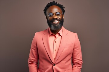 Obraz premium Portrait of a content afro-american man in his 40s dressed in a stylish blazer over blank studio backdrop