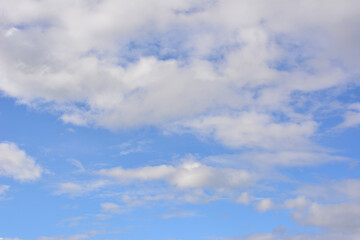 a sky with clouds and a bird flying in the sky  