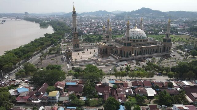 Aerial view of Baitul Muttaqien Mosque, the biggest mosque and islamic center in Samarinda, East Kalimantan, Indonesia. Located on the banks of the Mahakam River.