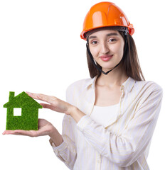 A young girl architect in a construction helmet demonstrates a model of a green house. Sale of ecological real estate.